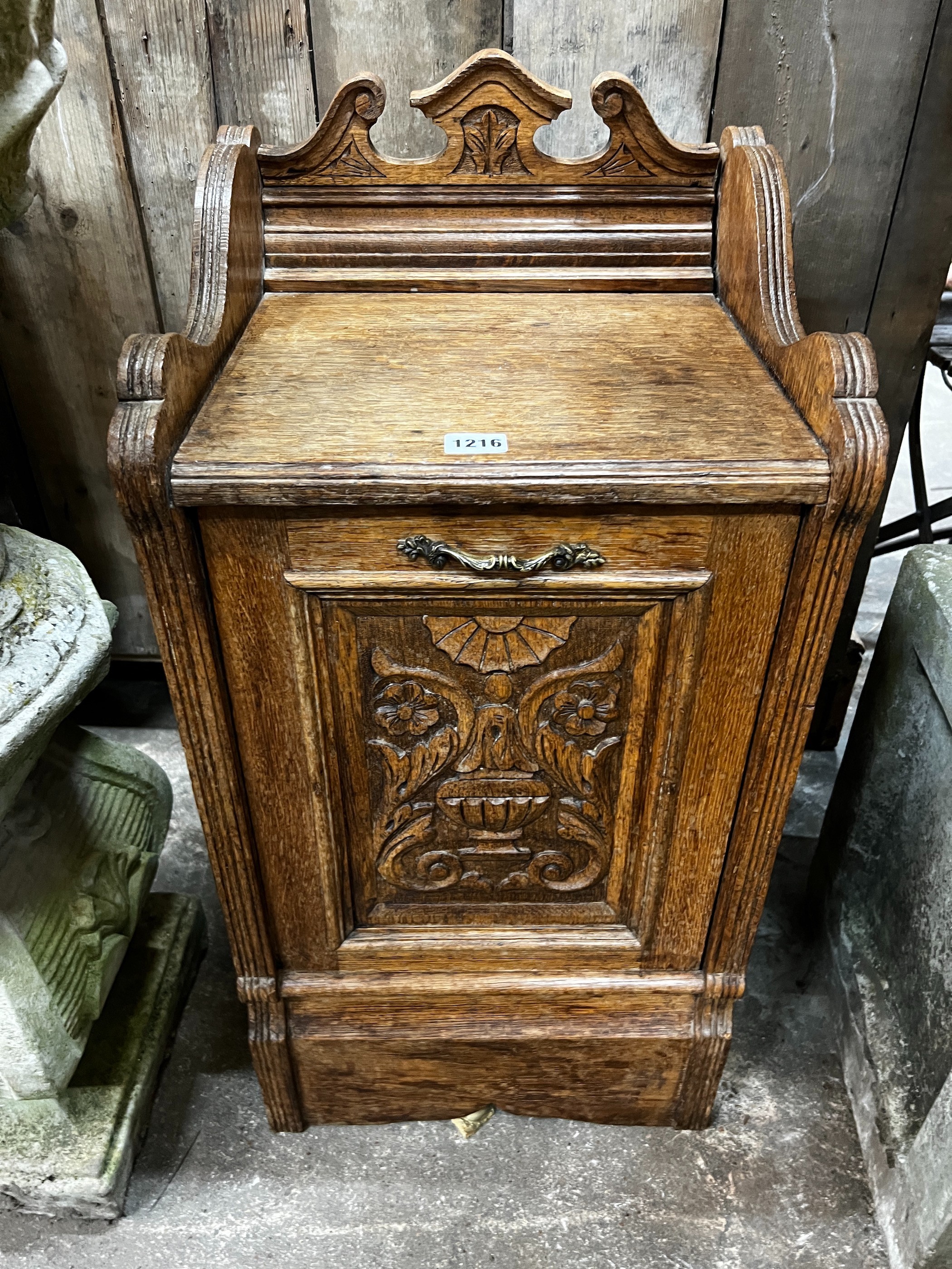 A Victorian carved oak coal purdonium, width 38cm, depth 35cm, height 75cm